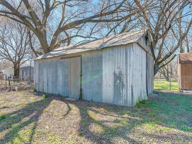 view of shed featuring fence