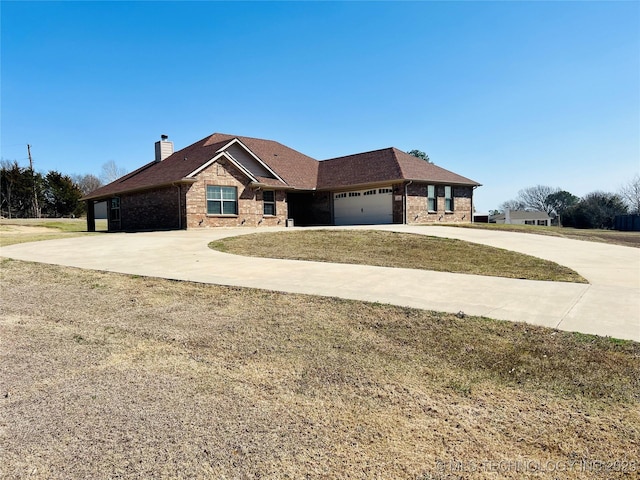 view of front of house with driveway, a shingled roof, a chimney, a garage, and brick siding