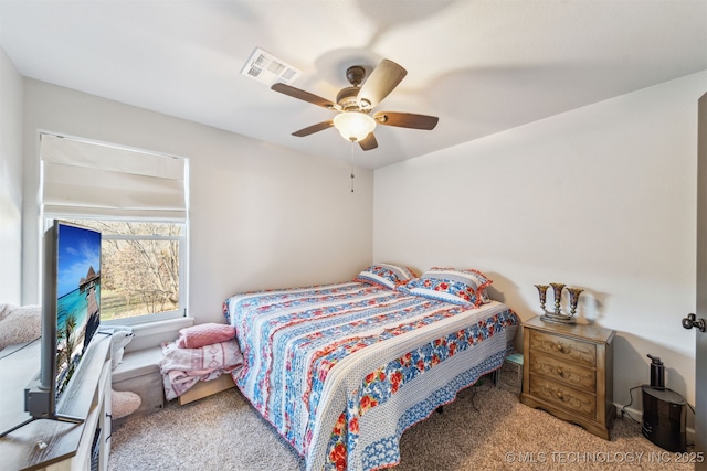 carpeted bedroom with visible vents and a ceiling fan