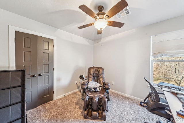 carpeted office featuring visible vents, a ceiling fan, and baseboards