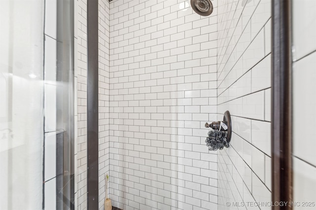 full bath with a tile shower