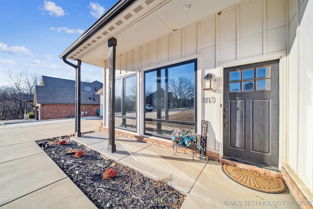 property entrance featuring board and batten siding