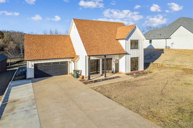 view of front facade with driveway, a shingled roof, a garage, and board and batten siding