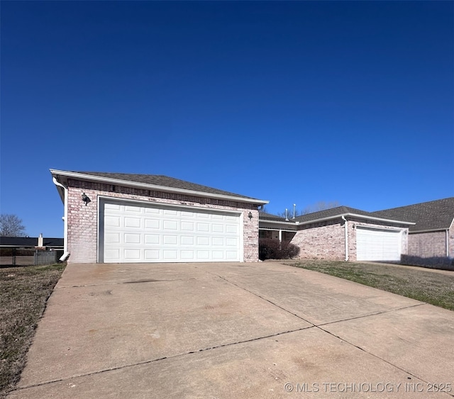 exterior space featuring brick siding and a garage