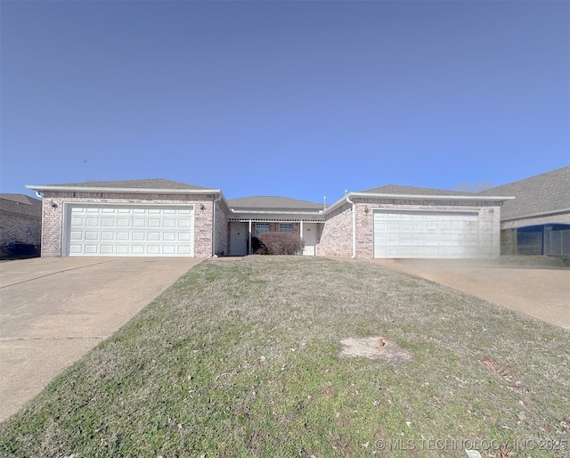 ranch-style house featuring driveway, brick siding, an attached garage, and a front lawn