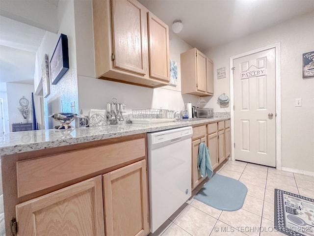 kitchen with light tile patterned floors, light brown cabinets, white dishwasher, and light stone countertops