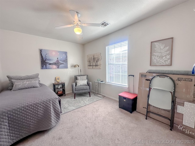 bedroom with visible vents, baseboards, ceiling fan, and carpet floors