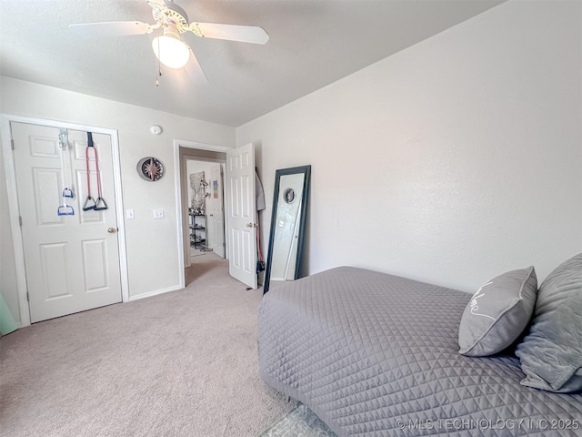 bedroom with a ceiling fan, baseboards, and light carpet