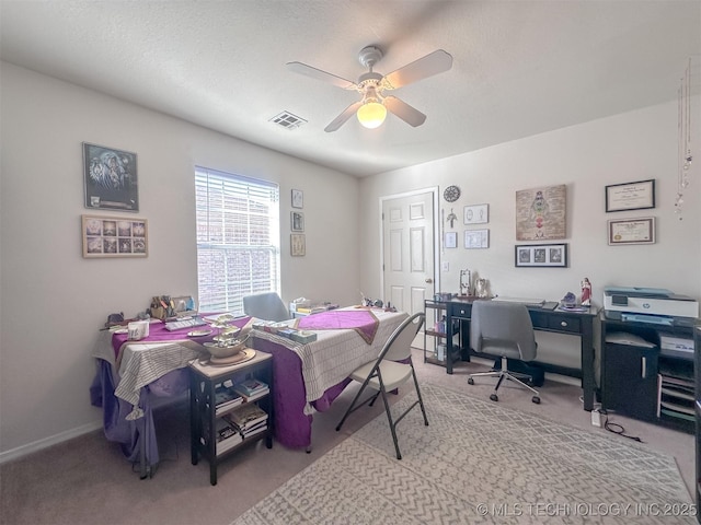 carpeted bedroom with a textured ceiling, baseboards, visible vents, and ceiling fan