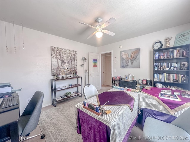 bedroom featuring a ceiling fan, carpet, baseboards, and a textured ceiling