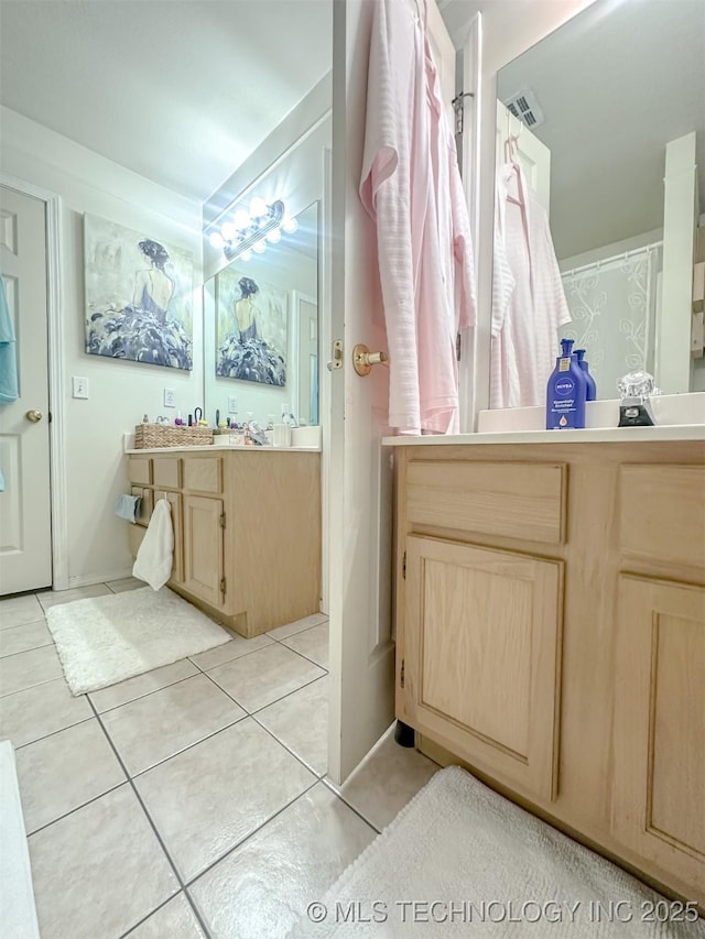 bathroom with tile patterned floors, visible vents, and vanity