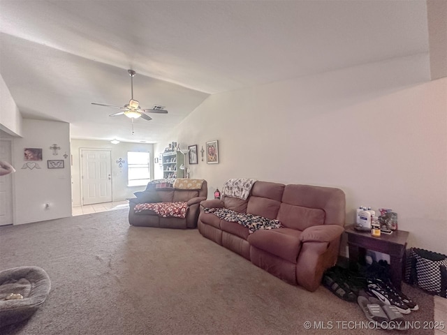 carpeted living area with ceiling fan and lofted ceiling