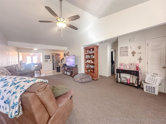 carpeted living room with a ceiling fan and vaulted ceiling