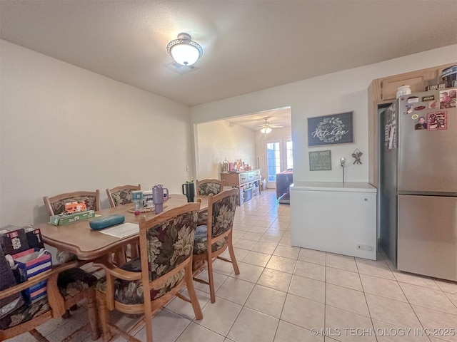 dining area with light tile patterned floors and a ceiling fan