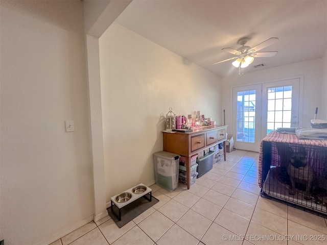 bedroom featuring access to outside, light tile patterned floors, visible vents, and ceiling fan