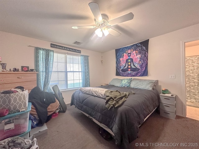 carpeted bedroom featuring visible vents and a ceiling fan