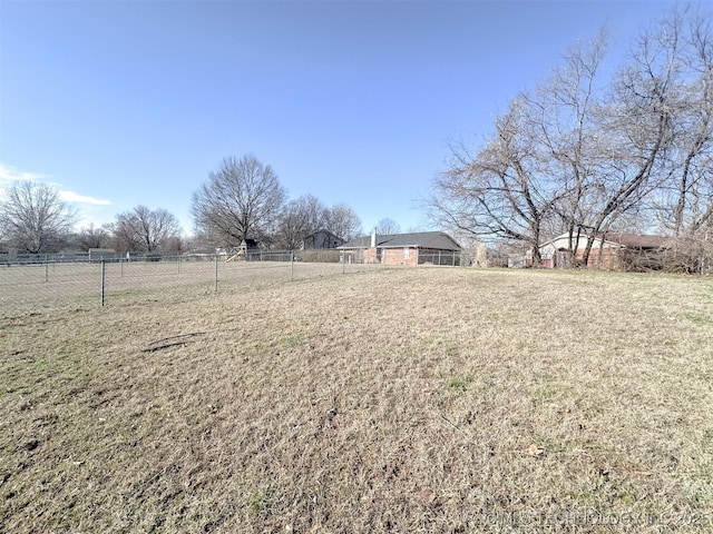 view of yard featuring a rural view and fence