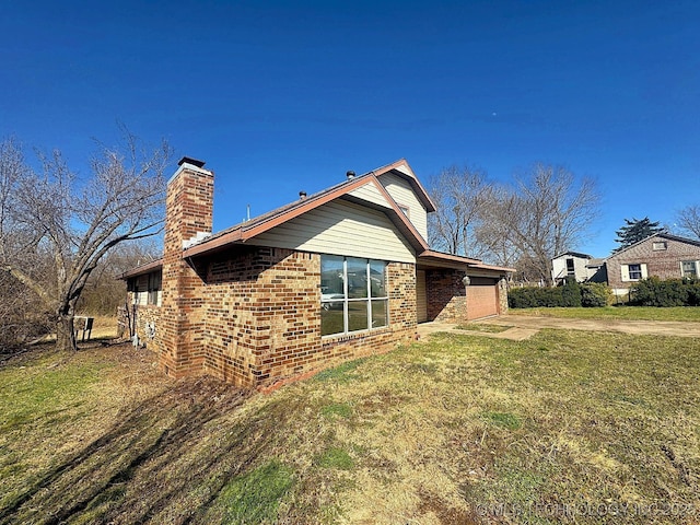 view of home's exterior featuring brick siding, a lawn, and a chimney