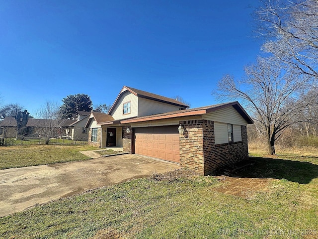 view of front of property with concrete driveway, brick siding, and a front yard