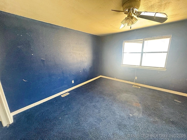 carpeted empty room featuring baseboards and visible vents