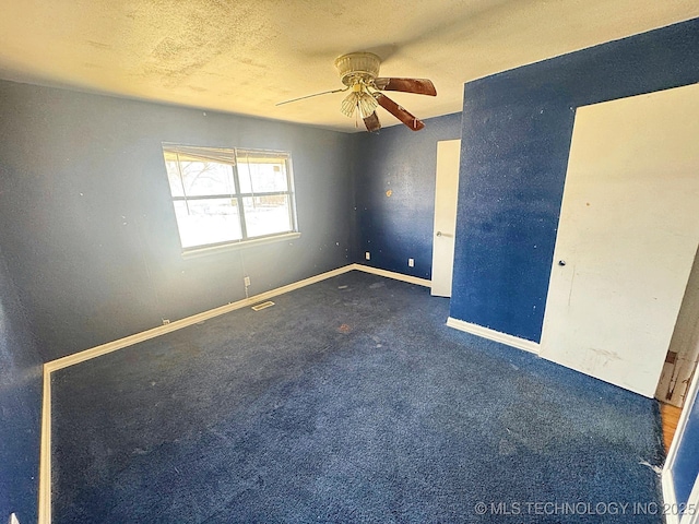 unfurnished bedroom featuring visible vents, ceiling fan, baseboards, carpet floors, and a textured ceiling