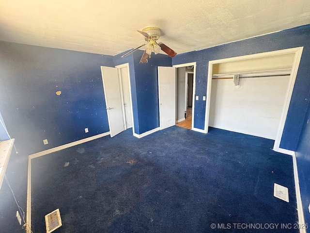 unfurnished bedroom featuring ceiling fan, baseboards, and carpet floors