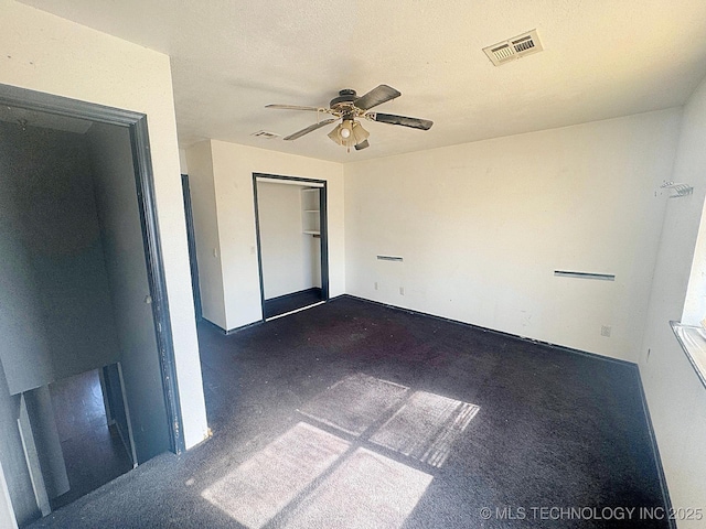 unfurnished bedroom with visible vents, a textured ceiling, a closet, and ceiling fan