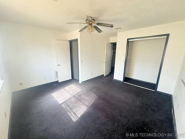 unfurnished bedroom featuring visible vents, baseboards, a textured ceiling, and ceiling fan