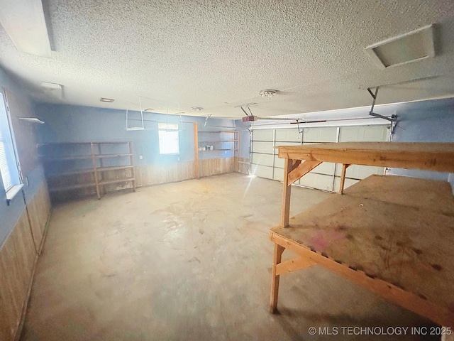 basement with a garage and a textured ceiling