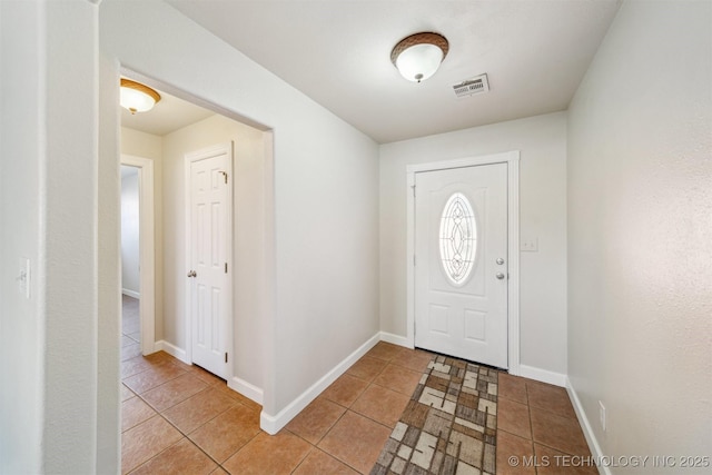 entryway with light tile patterned floors, visible vents, and baseboards