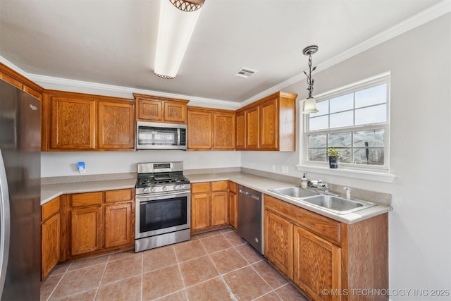 kitchen with brown cabinets, visible vents, appliances with stainless steel finishes, and a sink