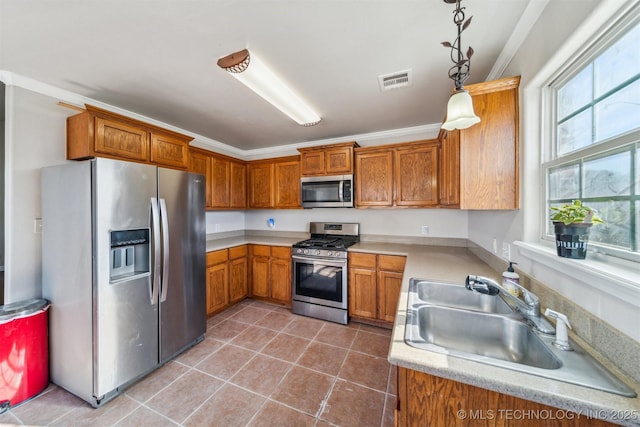 kitchen featuring a sink, brown cabinets, visible vents, and stainless steel appliances