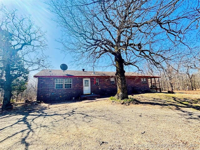 single story home featuring brick siding