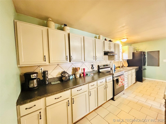 kitchen featuring dark countertops, electric range, backsplash, and under cabinet range hood