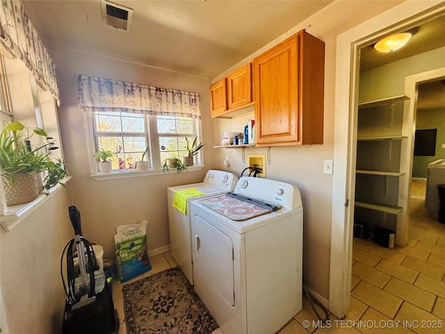 laundry area featuring cabinet space, visible vents, and independent washer and dryer