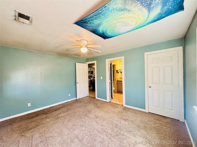 unfurnished bedroom with carpet, visible vents, ensuite bathroom, and baseboards