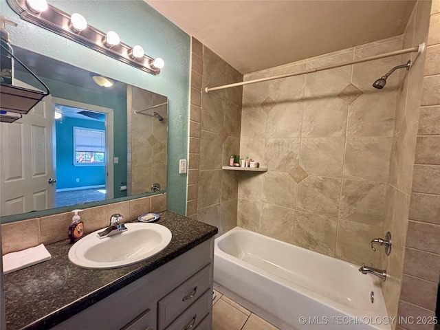 bathroom with tile patterned flooring, vanity, shower / bathing tub combination, and a textured wall