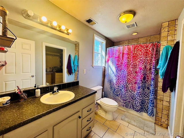 bathroom with tile patterned flooring, visible vents, vanity, a shower with curtain, and a textured ceiling