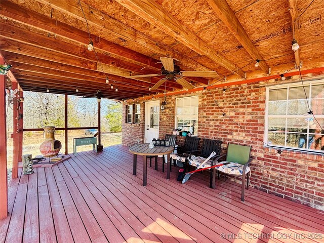 wooden terrace featuring a ceiling fan