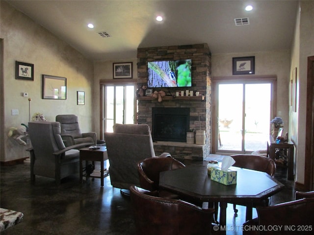 dining space with recessed lighting, visible vents, lofted ceiling, and a stone fireplace