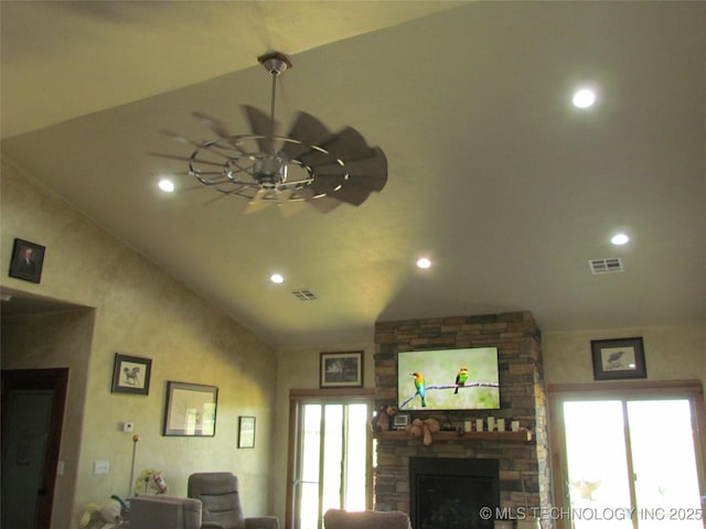 living room with lofted ceiling, recessed lighting, a fireplace, and visible vents