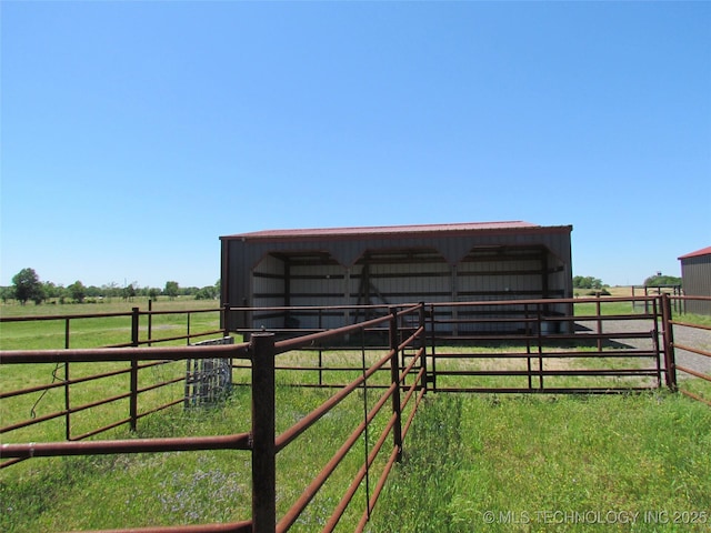 view of outbuilding featuring an outbuilding, a rural view, and an exterior structure