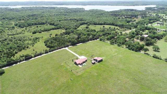 drone / aerial view with a water view, a view of trees, and a rural view