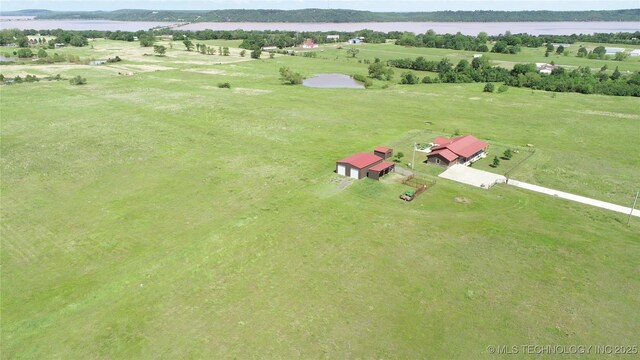 birds eye view of property featuring a rural view and a water view