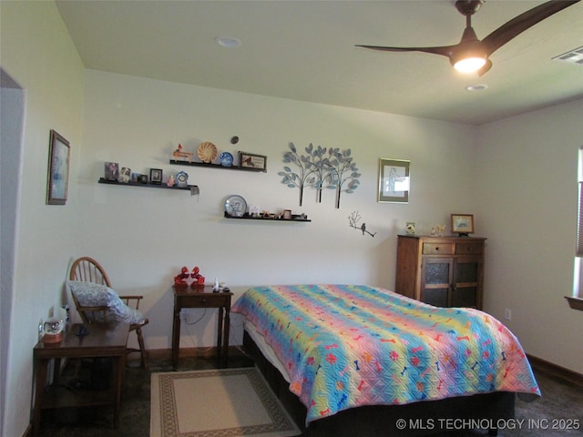 bedroom with baseboards, visible vents, and ceiling fan