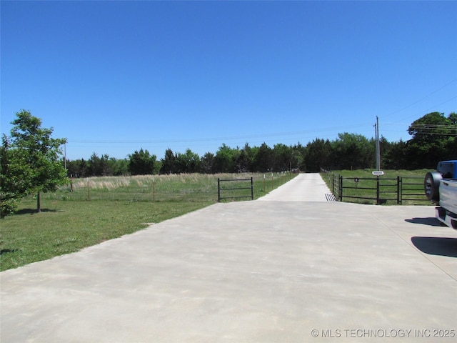 view of street featuring concrete driveway