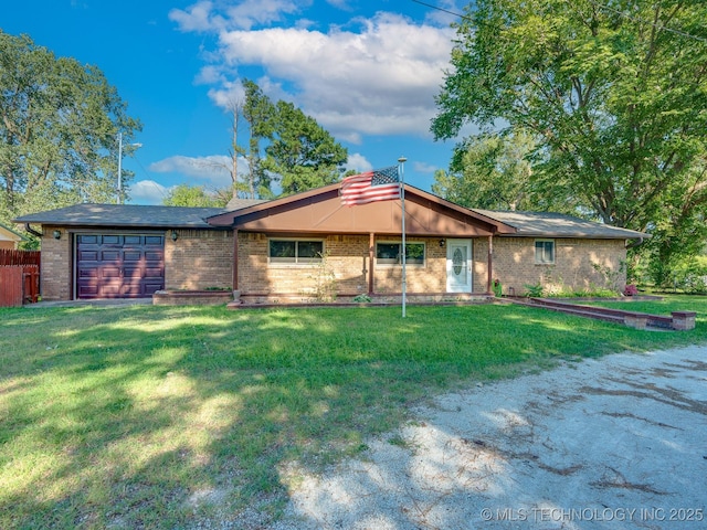 ranch-style home with brick siding, an attached garage, and a front yard