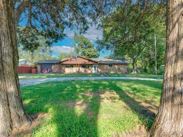 single story home featuring brick siding, a front lawn, and fence