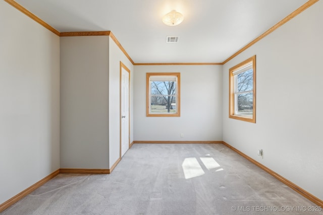 unfurnished room with plenty of natural light, baseboards, and visible vents