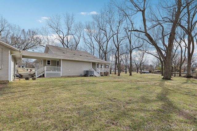 view of yard with central AC unit and a porch